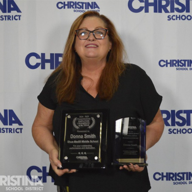 Photo of Donna 2024-2025 Paraprofessional Employee Champion of the Year holding awards